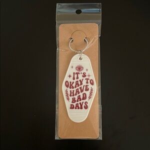 White Motel Keychain with Red Text